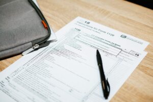 Empty tax form on a desk next to a laptop