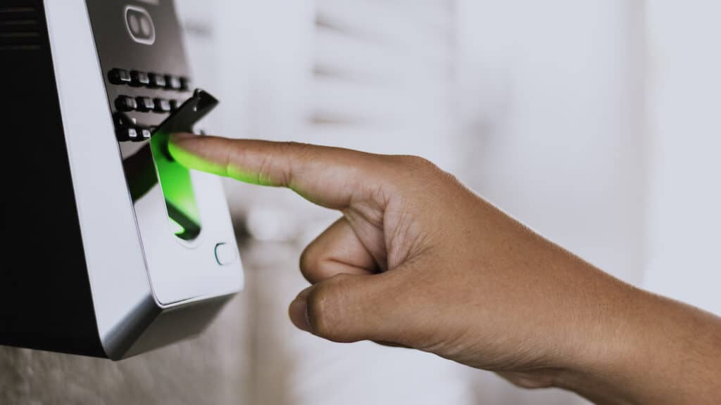 Person performing a biometric finger scan for controlled access into the building.