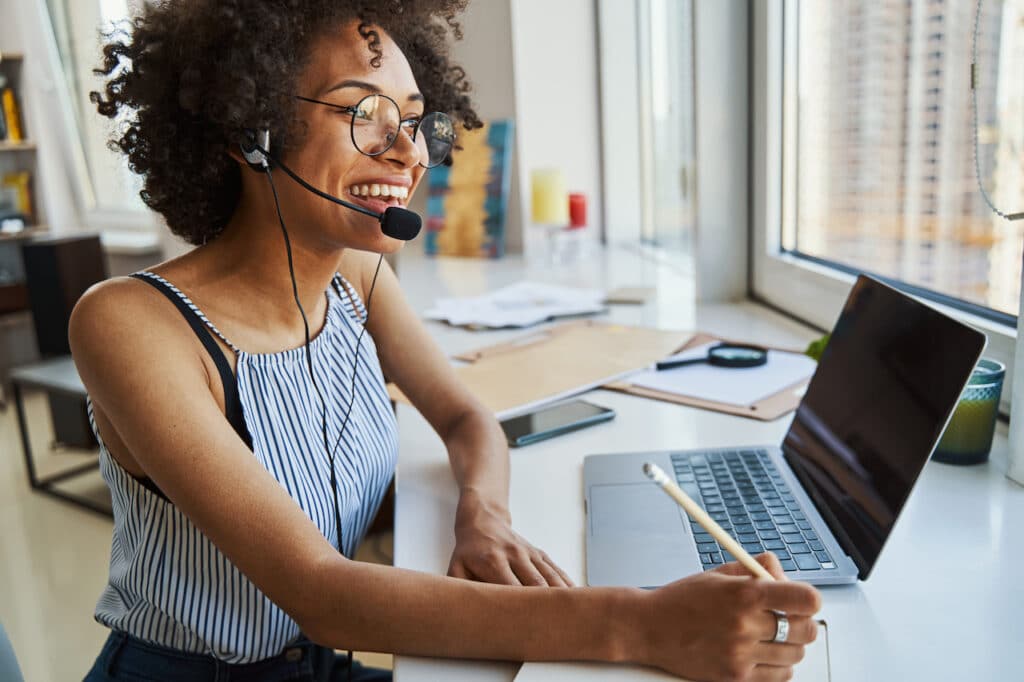 Female remote worker on a call using work from home equipment