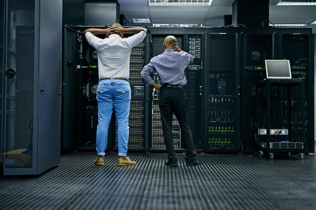 Two IT technicians having difficulty with a data disaster recovery for a construction company.